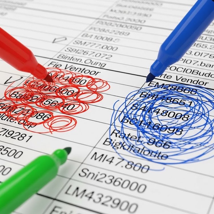 Paper with columns of values being marked up with red and blue pens