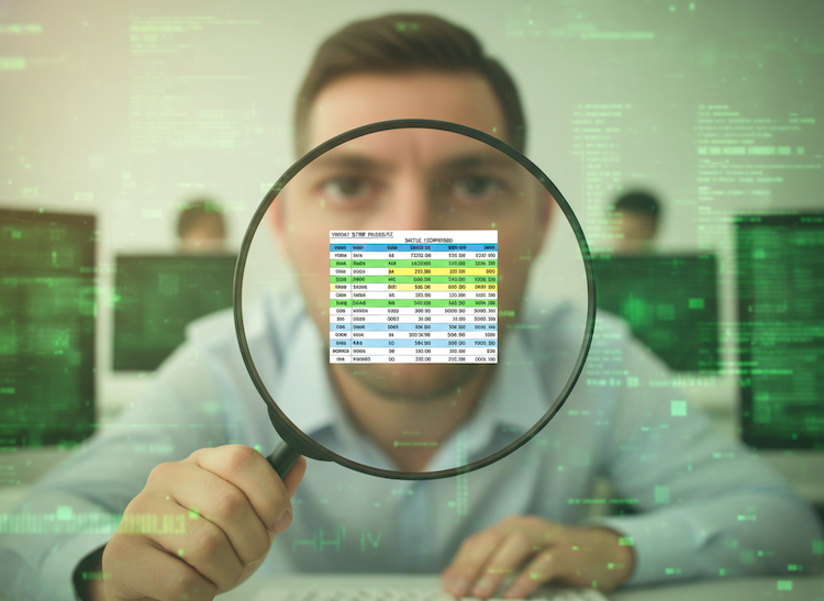 man with magnifying glass looking at a tiny spreadsheet
